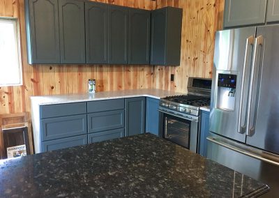 Gray kitchen cabinets with custom natural stone granite countertop by Gordon Creek Granite of Hicksville, Ohio.