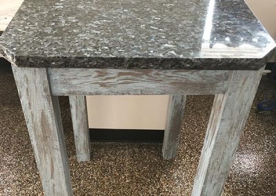 Wood table with custom natural stone top by Gordon Creek Granite of Hicksville, Ohio.