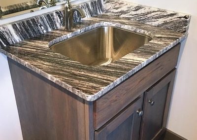 Wood bath cabinet vanity with custom natural stone granite countertop by Gordon Creek Granite of Hicksville, Ohio.