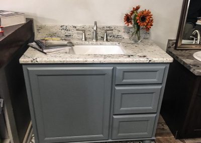 Gray vanity cabinet with custom natural stone granite countertop by Gordon Creek Granite of Hicksville, Ohio.