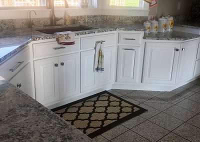 White kitchen cabinets with custom natural stone granite countertop by Gordon Creek Granite of Hicksville, Ohio.